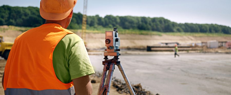 Builder in orange helmet and vest on a building place